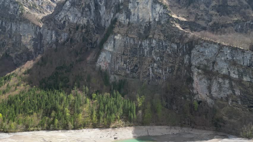 Aerial backwards view of mountain range in its immensity. Switzerland. Orbit ascending