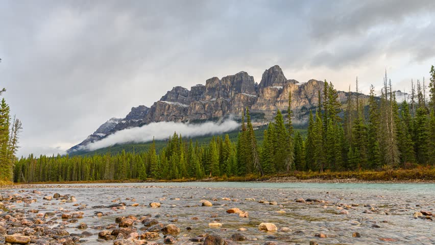 Time lapse of Scenery of sunrise over Castle mountain and bow river flowing in the morning at Banff national park, Alberta, Canada