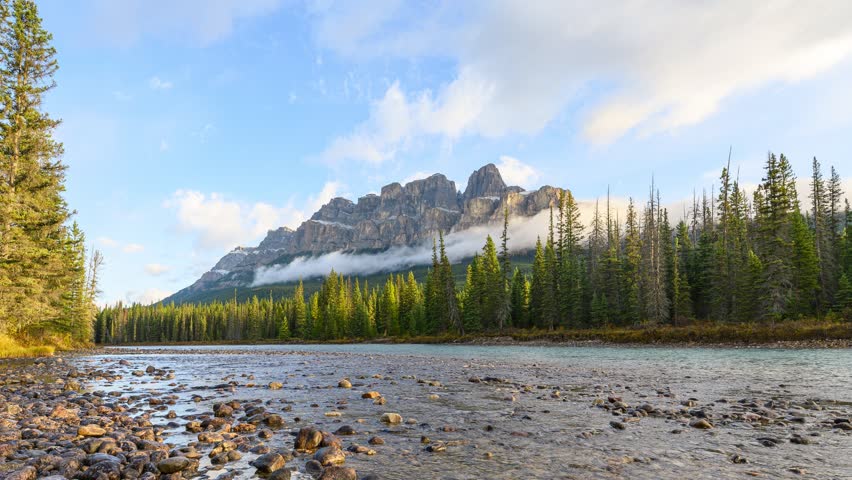Time lapse of Scenery of sunrise over Castle mountain and bow river flowing in the morning at Banff national park, Alberta, Canada