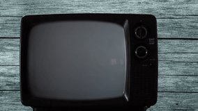 Male Hand turning On a Retro TV with Blue Screen. Close-Up. 4K Resolution.