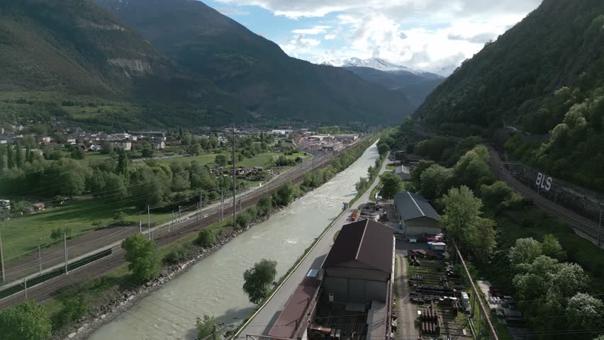 A large river separates the valley between the two mountains. It is the place Brig in the canton Valais in Switzerland