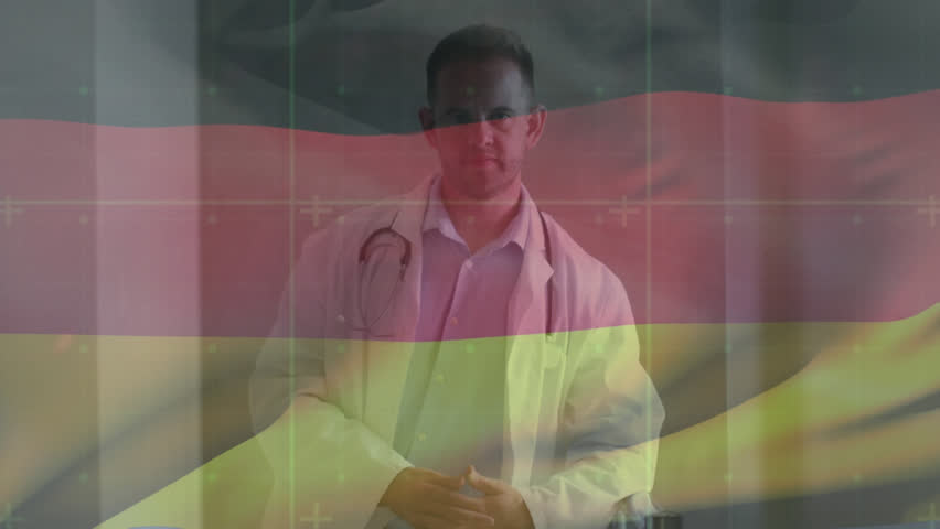 Animation of waving german flag against biracial male senior doctor standing at hospital. National healthcare technology concept