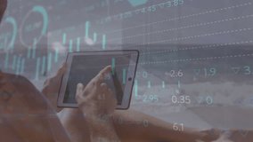 Animation of graphs, globe and trading board over caucasian man using digital tablet at beach. Digital composite, multiple exposure, globalization, report, business, stock market, leisure concept. - Powered by Shutterstock - Get 15% off with code: PIKWIZARD15