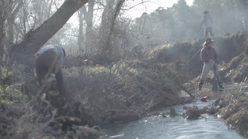 CALIFORNIA - 2022. Re-enactment recreation of California Gold Rush - Gold Miners digging and finding gold in mid-19th century. 1800s Western. 1840-1890s western life. Panning for gold in river, shovel
