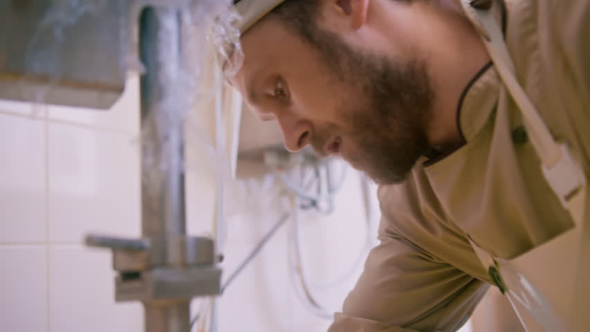 milk mixing at cheese factory cheese maker checks by hand in large tank Pasteurization Cheese production cheese factory