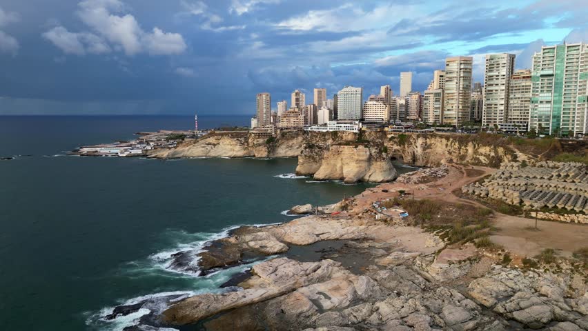 Wide angle establishing drone shot Raouche rocks and coast in Beirut Royalty-Free Stock Footage #1105090897