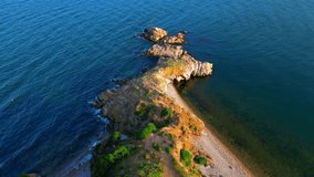  sea cliff in sunset light blue water. - stock video from bird's eye view of a flying drone