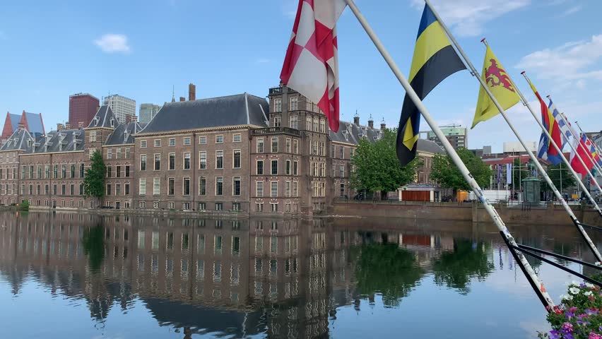 View of Binnenhof. Dutch government and office of Prime minister. Dutch provinces (municipalities) flags are waving in front. Den Haag skyline. The Hague, South Holland, Netherlands