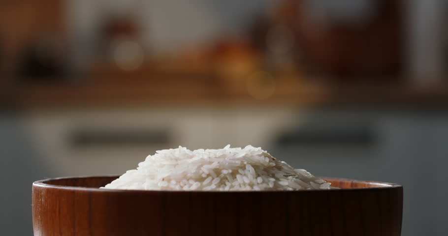 Rice fall into raw wooden cup side view home kitchen blurred background Sushi sashimi, Japanese Asian Ethnicity cookery. Wooden rice bowl, healthy clean eating. Grain seed vegan uncooked white rice Royalty-Free Stock Footage #1105099747