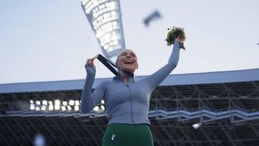 Young Female Athlete Celebrates a Win on a podium, receives a gold medal. Super slow motion, shot on RED cinema camera - Powered by Shutterstock - Get 15% off with code: PIKWIZARD15