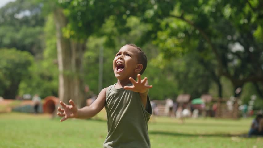Happy kid is play in park. Little boy play with soap bubbles. Kid smile and run through forest park.Smile of happy child. Baby smile and bursts soap bubbles. Child play. Child run forest park for soap Royalty-Free Stock Footage #1105104905