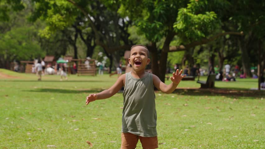 Happy kid is play in park. Little boy play with soap bubbles. Kid smile and run through forest park.Smile of happy child. Baby smile and bursts soap bubbles. Child play. Child run forest park for soap Royalty-Free Stock Footage #1105104977