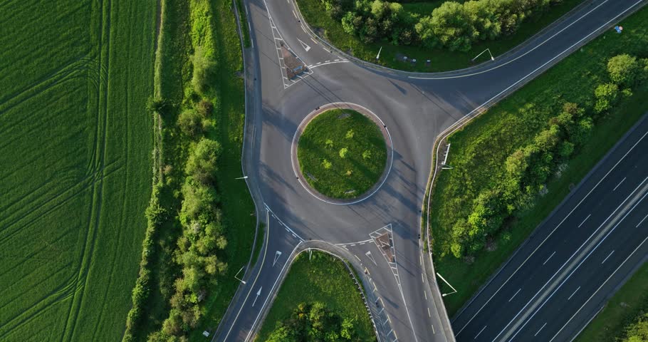 5k footage of a drone. Roundabout aerial top view with cars passing by Royalty-Free Stock Footage #1105105437