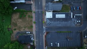 Overhead view of downtown Milton, Pennsylvania with a car moving along with drone video looking down, moving forward.