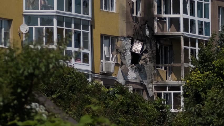 A charred destroyed building as a result of bombing as a result of military clashes. Broken window and glass
