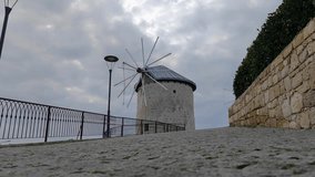 Historical windmill in izmir Alaçatı on a cloudy day, time lapse video
