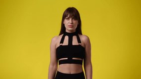 4k video of one girl posing for a video over yellow background.