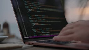 Young female developer working on laptop by the ocean at sunset. Woman freelancer coding at outdoor tropical cafe. Caucasian girl working remotely typing on computer at exotic location close-up - Powered by Shutterstock - Get 15% off with code: PIKWIZARD15
