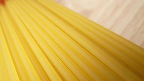 Coarser, thicker dry spaghetti noodles stand tall, showcasing their rough texture and sturdy structure under the macro lens. Raw material and food concept. Food pattern. Spaghetti background. 4K HDR
