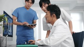 A group of medical staff having a meeting while looking at a PC screen.　Teamwork of medical occupation. - Powered by Shutterstock - Get 15% off with code: PIKWIZARD15