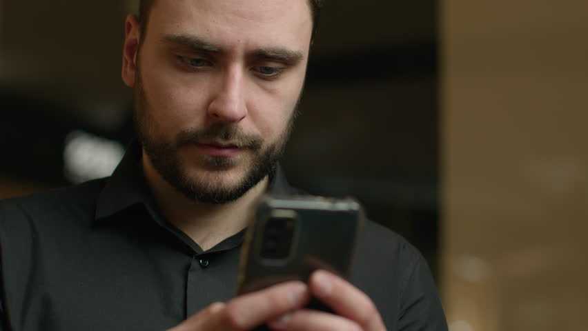 Focusing on smartphone gadget addicted man Caucasian businessman male entrepreneur typing message texting sms chatting on mobile phone in office serious male guy shopping online booking internet order - Powered by Shutterstock - Get 15% off with code: PIKWIZARD15