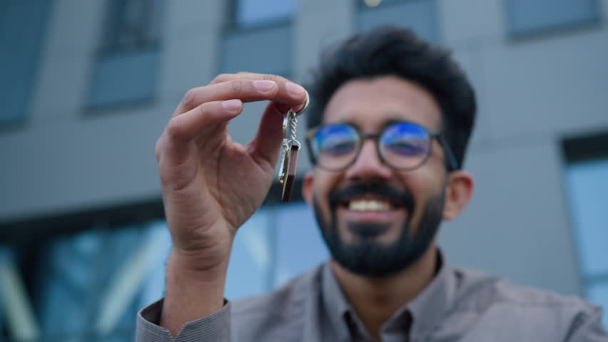 Smiling Arabian man businessman real estate agent business broker hold bunch of keys rental office building in city male apartment owner selling new skyscraper rent house mortgage company relocation Royalty-Free Stock Footage #1105125847