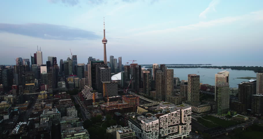 Aerial view away from downtown Toronto, sunset in Canada - pull back, drone shot