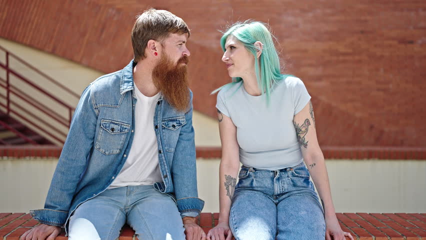 Man and woman couple smiling confident speaking at street