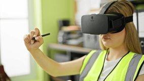 Young blonde woman architect using virtual reality glasses drawing at office