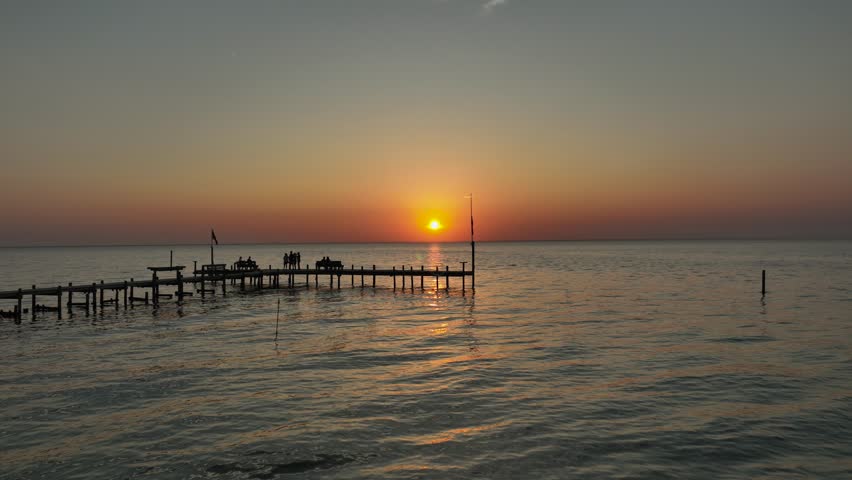 Aerial pan view of sunset over Mobile Bay, Alabama
