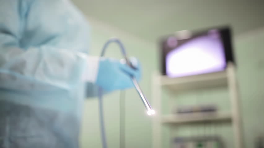 Surgeon meticulously readies the camera probe and equipment, ensuring precision and readiness for a surgical procedure.
 Royalty-Free Stock Footage #1105137049