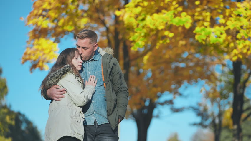 Happy and in love young couple in the park in the fall. Royalty-Free Stock Footage #1105138951