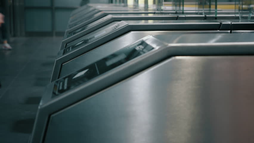 Lot of people passengers going through automatic turnstiles in subway station, entrance tourniquet to metro railway train platform. Ticket scanner. Long exposure, time-lapse blurred fast motion Royalty-Free Stock Footage #1105141553