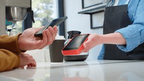 Close-up: a customer makes a purchase in a coffee shop, pays with a QR code. Scans the QR code with a smartphone in the bank's application. New technologies in digital finance. Electronic payment - Powered by Shutterstock - Get 15% off with code: PIKWIZARD15