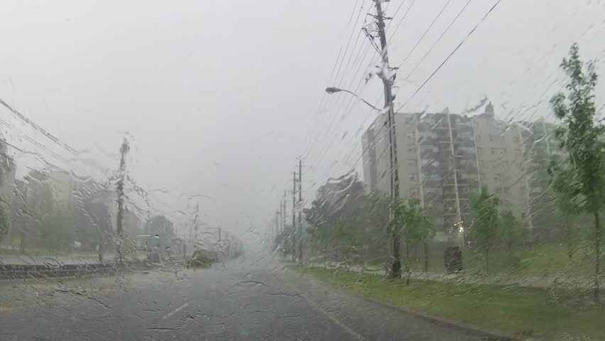 Dangerous poor visibility during unexpected hail, suddenly hit Scarborough and Toronto, Ontario, Canada. Severe thunderstorm starts while driving in the car at the road. Environmental disaster. | Shutterstock HD Video #1105144513