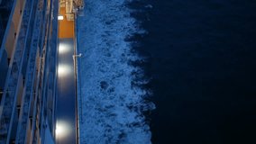 view of the wake beside a large cruise ship with lifeboat while cruising in deep international sea blue caribbean water in night time.Ocean view wake trace of cruise ship.vacation travel tropical sea. - Powered by Shutterstock - Get 15% off with code: PIKWIZARD15