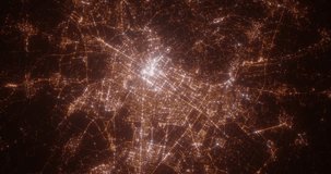 Turin (Italy) aerial view at night. Top view on modern city with street lights. Camera is zooming out, rotating clockwise. Vertical video. The north is on the left side