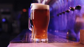 Close-up image of beer glasses with dark and lager beer in neon. Selective focus. Cool, chill drink. Refreshment. Bar, pub atmosphere. Concept of alcohol drink, party, taste, relaxation. Ad - Powered by Shutterstock - Get 15% off with code: PIKWIZARD15