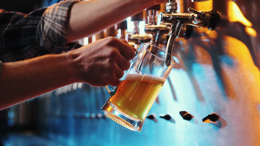 Close-up pf male hand of bartender pouring a large glass of lager beer with tap. Pouring beer for client at pub, bar. Beer degustation. Concept of alcohol drink, party, taste, relaxation. Ad Royalty-Free Stock Footage #1105151465