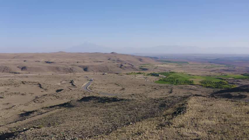 Backward reveal aerial shot of Saint Christopher Church on sunny summer day. Dashtadem, Aragatsotn Province, Armenia.