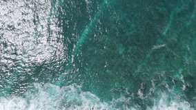 Aerial view of big turquoise waves of Indian ocean in Maldives. Exotic tropical landscape from above. Summer holiday or vacation travel concepts. 4K footage drone video