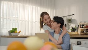 A happy and loving Asian couple shares joyful moments in their home kitchen, radiating love and playfulness. With genuine smiles and a relaxed vibe, Couple enjoy their time together in Kitchen - Powered by Shutterstock - Get 15% off with code: PIKWIZARD15