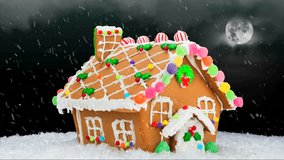 A gingerbread house during a cold, snowy Christmas evening shows a festive setting with a cloudy, black sky, bright moon and delicious cookie decoration. - Powered by Shutterstock - Get 15% off with code: PIKWIZARD15