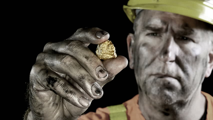 Conceptual video of a gold miner examining his giant precious metal discovery.