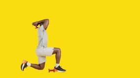 African man doing back triceps extension exercises with dumbbells