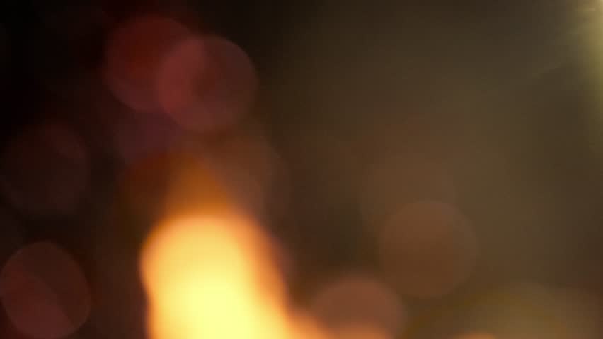 Being near an intense fire from a campfire at night, macro bokeh shot of the shimmering flame sparks. Enchanting ambiance, dancing blaze.
 Royalty-Free Stock Footage #1105167565