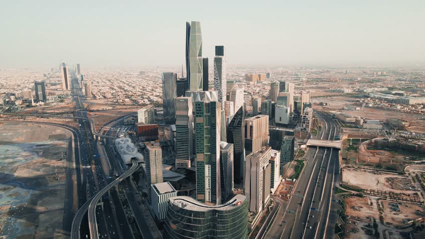 Drone video from above of the King Abdullah Financial District (KAFD) in the city of Riyadh, the financial city in the Kingdom of Saudi Arabia, the main destination for money and business in Riyadh Royalty-Free Stock Footage #1105173439