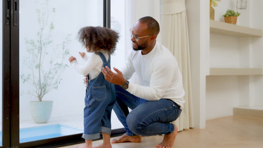 Happy african family parents and little children enjoy together and relaxing couple with kids having fun at home