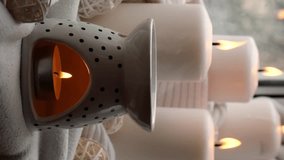 Vertical footage Aroma lamp with essential oil, aromatherapy at home, burning candle, dropping essential oil. Concept of home relaxation and anti stress. Natural Spa treatment Home fragnance at cozy - Powered by Shutterstock - Get 15% off with code: PIKWIZARD15