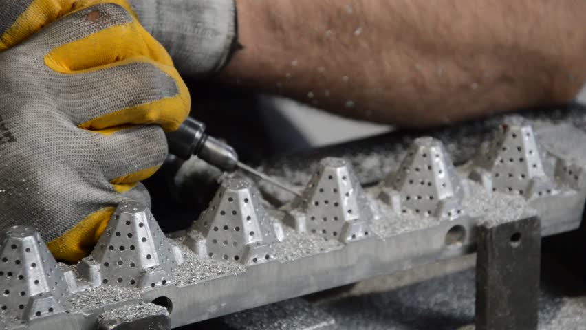 drilling a metal egg mold with a drill
